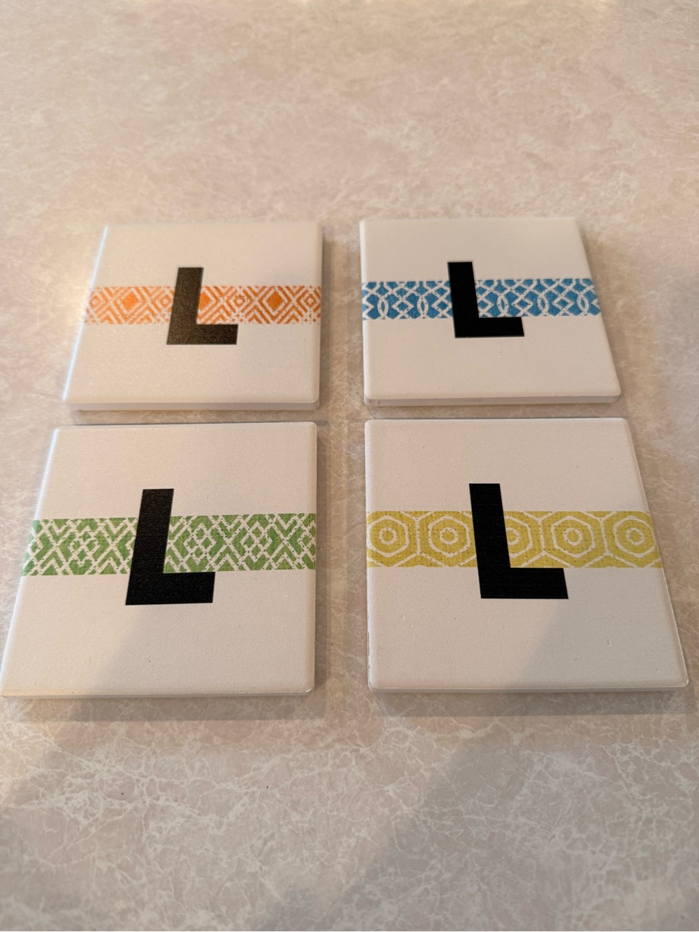 Food Network White Coasters with Black L and Orange, Blue, Green, Yellow Bands